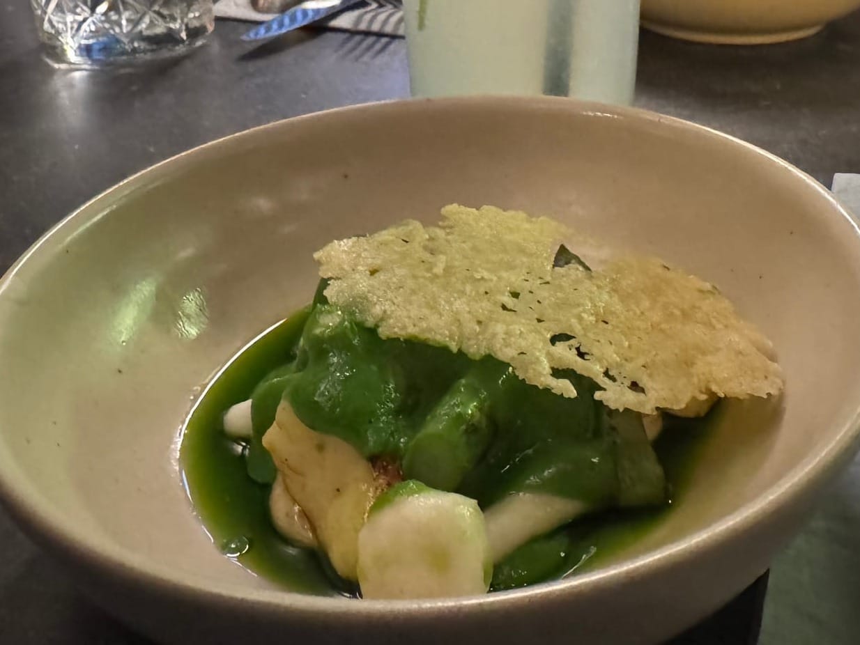 Jersey Royal gnocchi with spring pea and mint, asparagus, spring onion and a parmesan tuille.