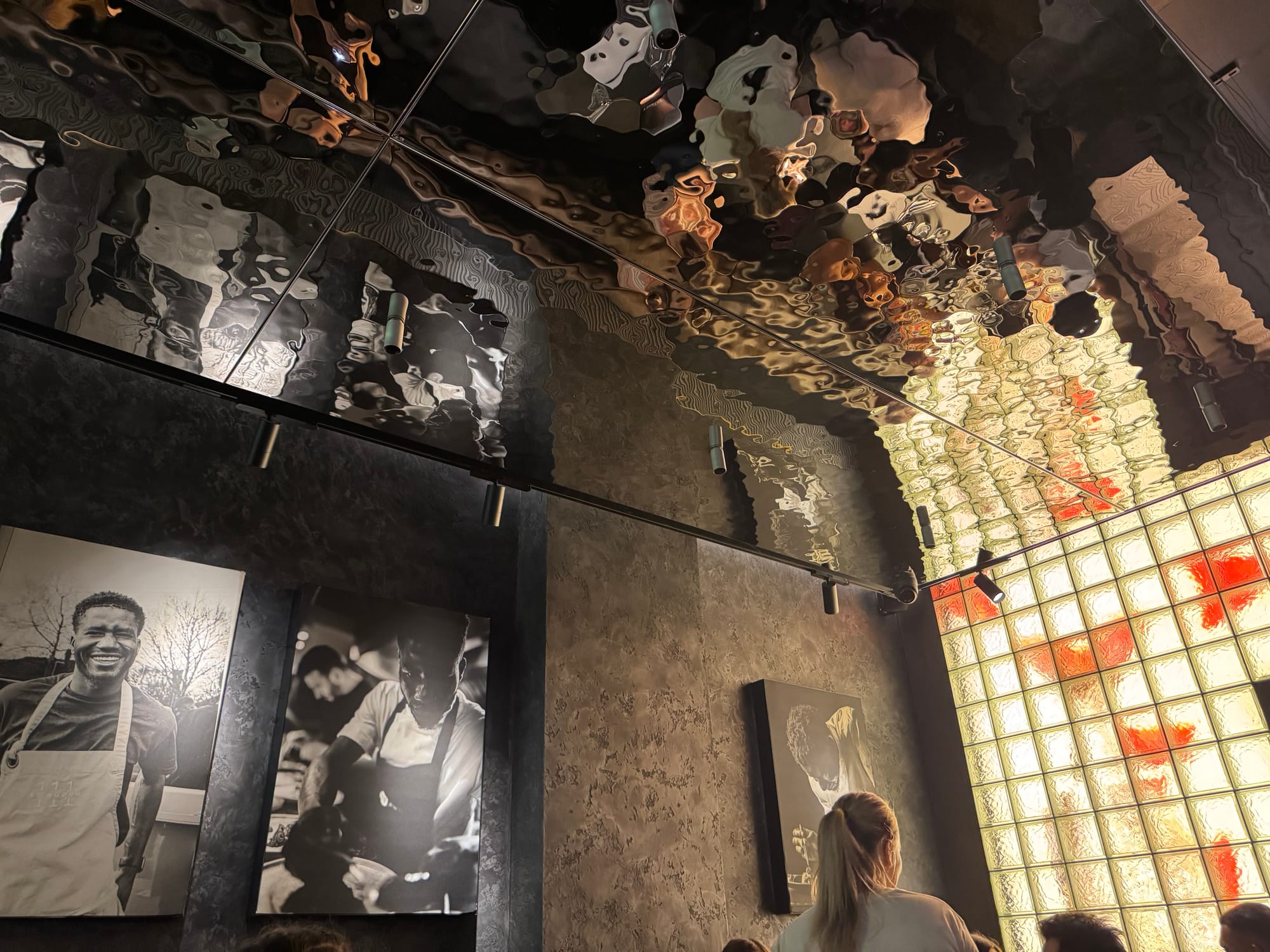 Canvases of Modou Diagne show his culinary career.