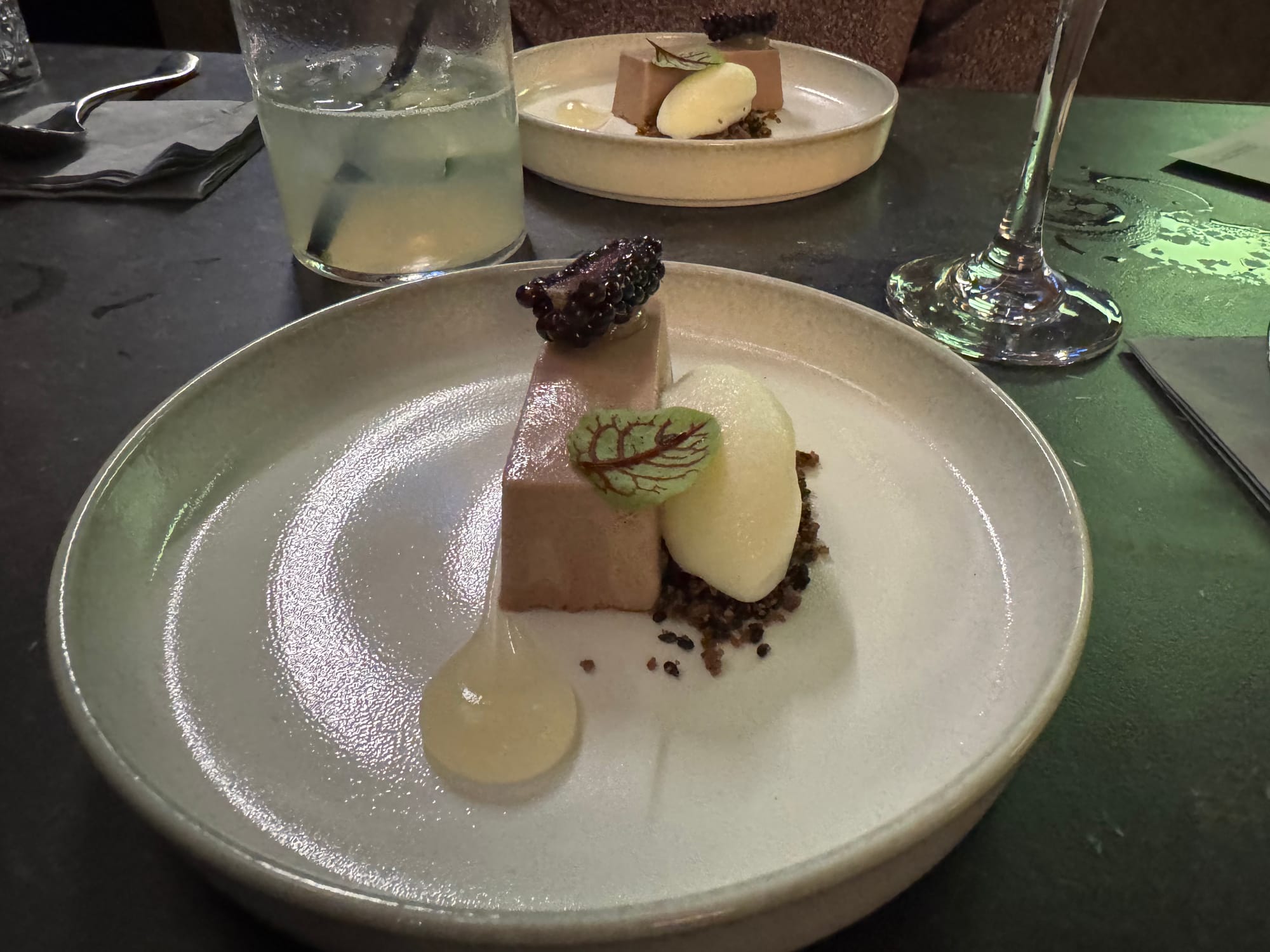 Blackberry Parfait, yoghurt, black sesame, and edible flower.