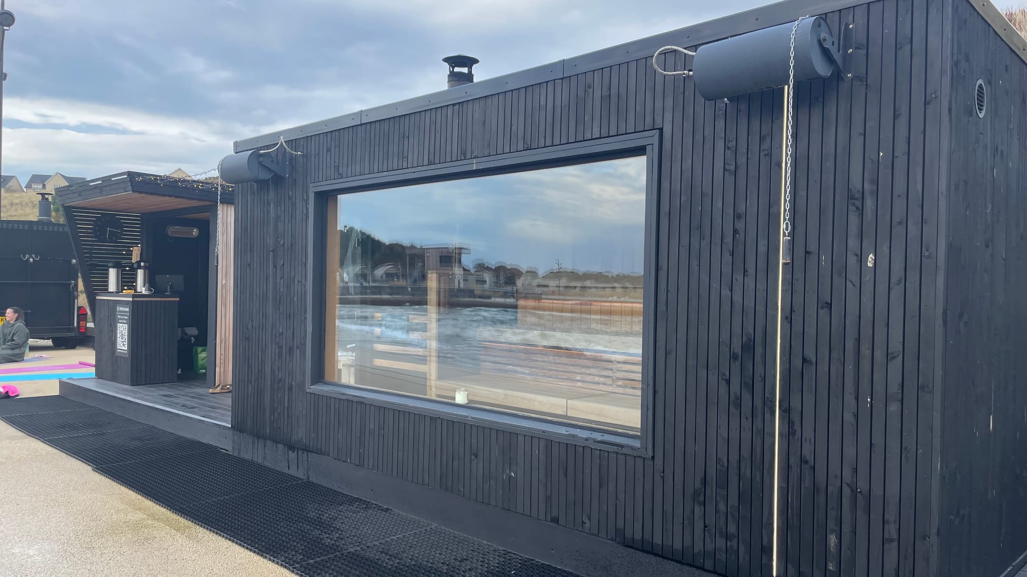 Painted black wood panels cover the exterior of Spear Sauna.