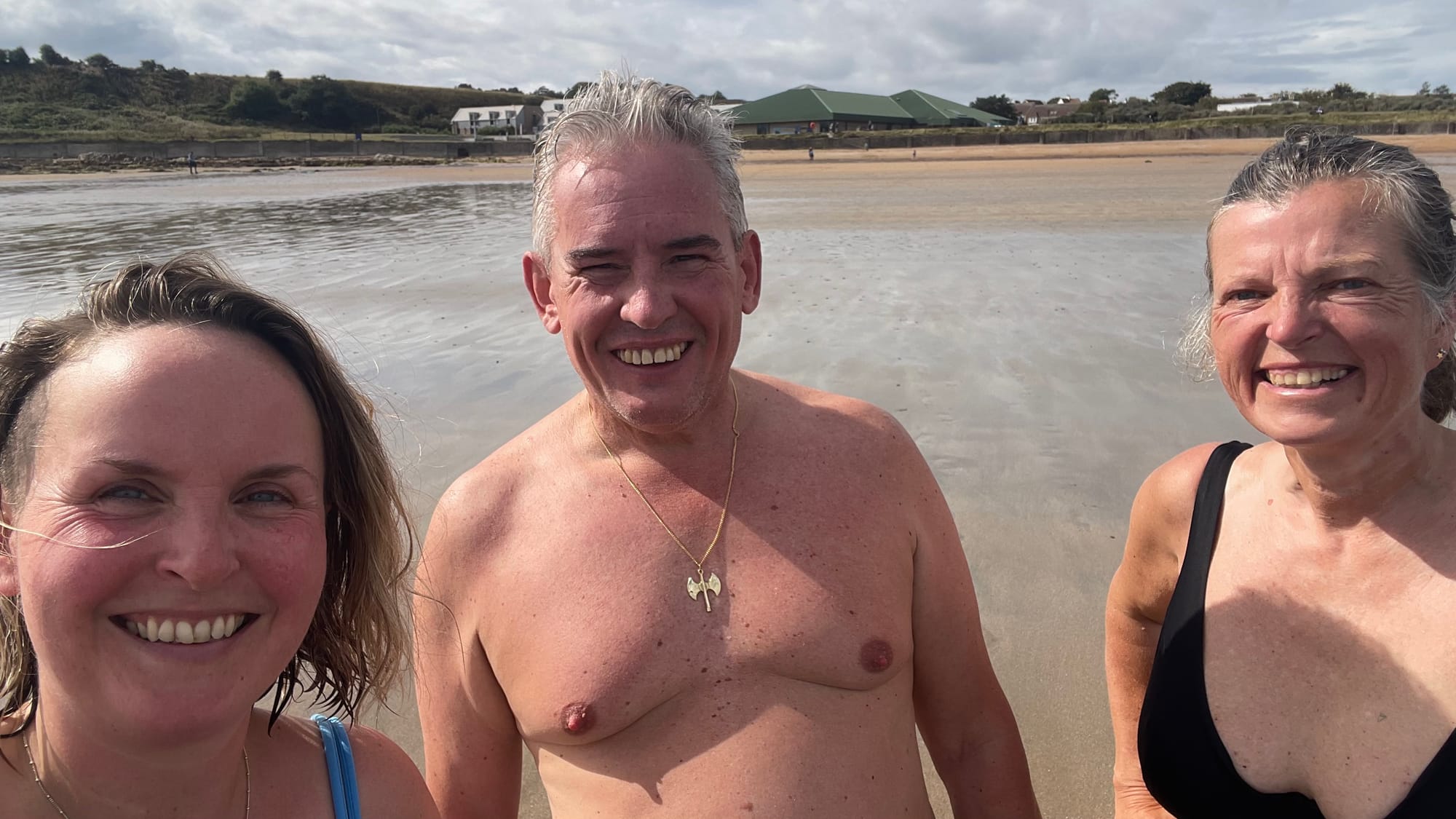 Rachel is on the left with sauna regular Nico and owner Judith as they smile for a selfie. East Sands beach is in the background.
