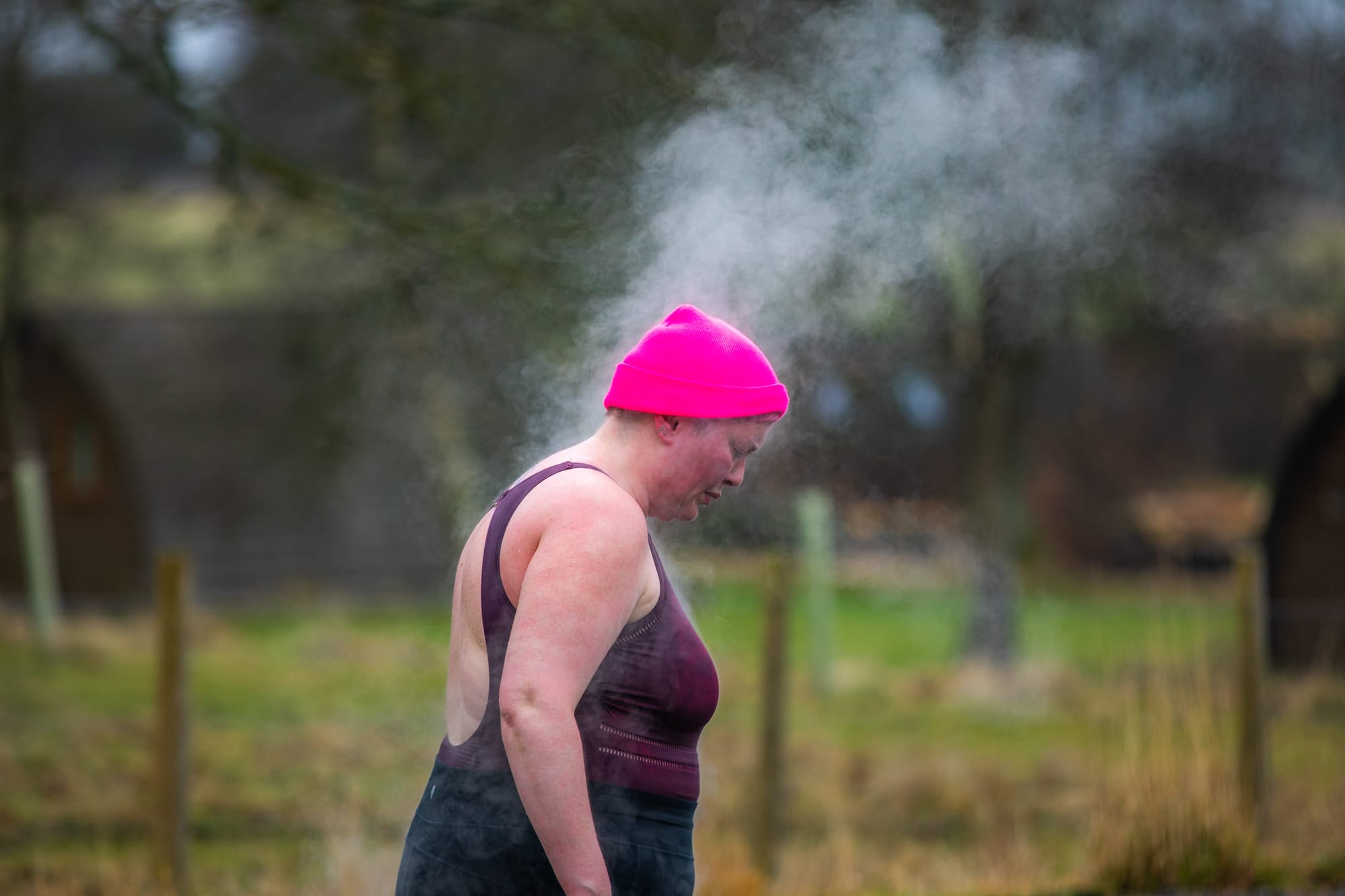 Steam is generated from a sauna user's head as they walk outside in the cool air.