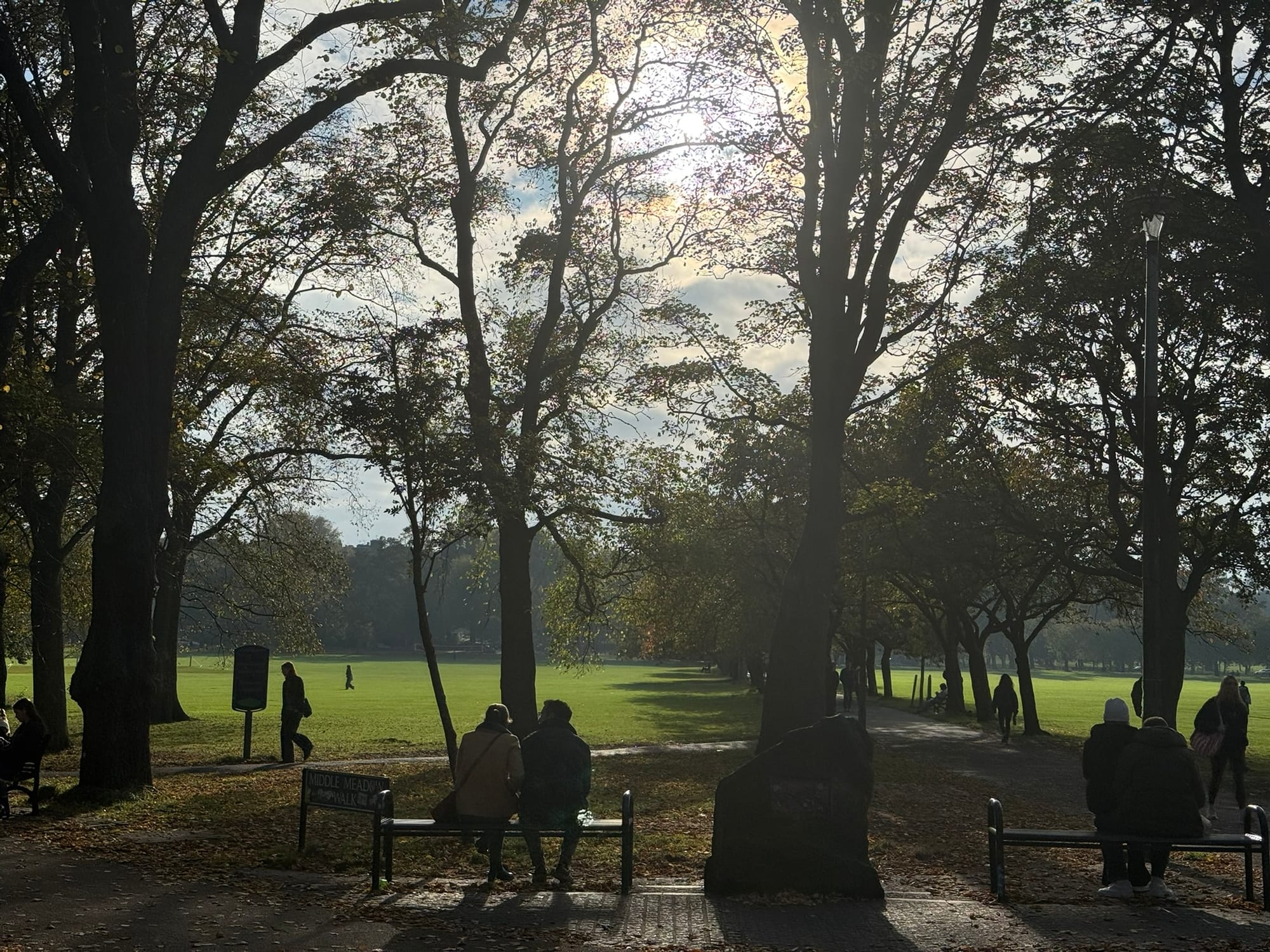 People enjoying the autumn sunshine at The Meadows.