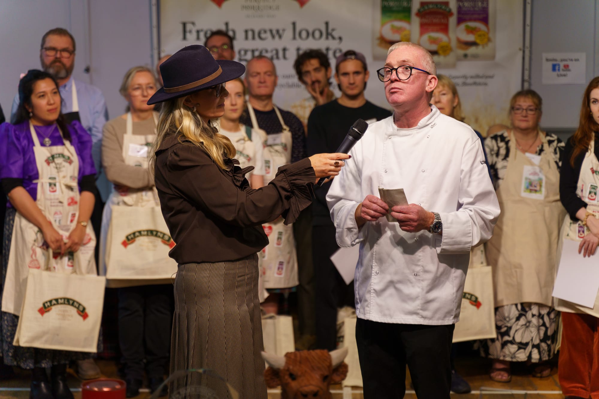 Chief judge Neil Mugg speaks to Sarah Rankin with the competitors behind them.