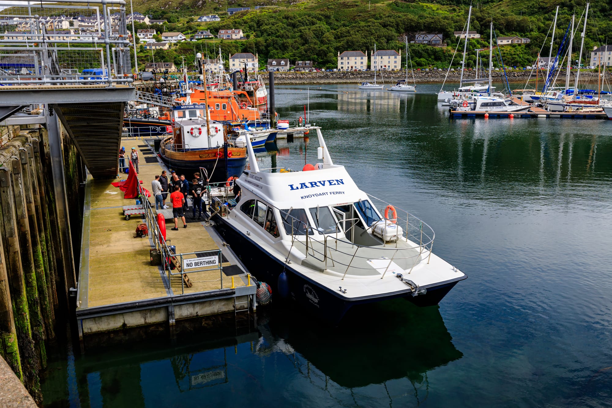 People waiting to board the Knoydart ferry leaving from Mallaig Harbour.