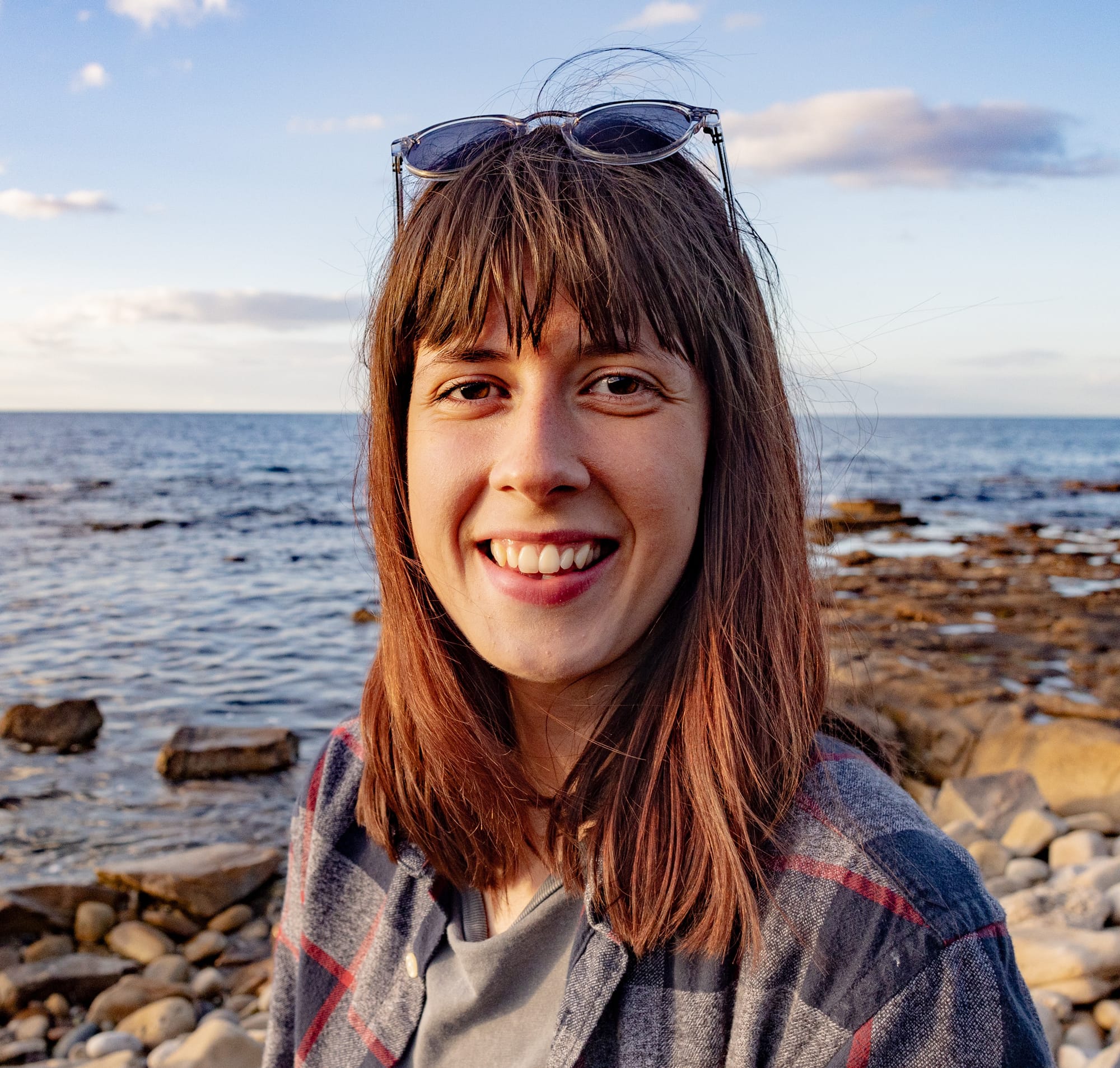 Rebecca Gibson smiling near the water.