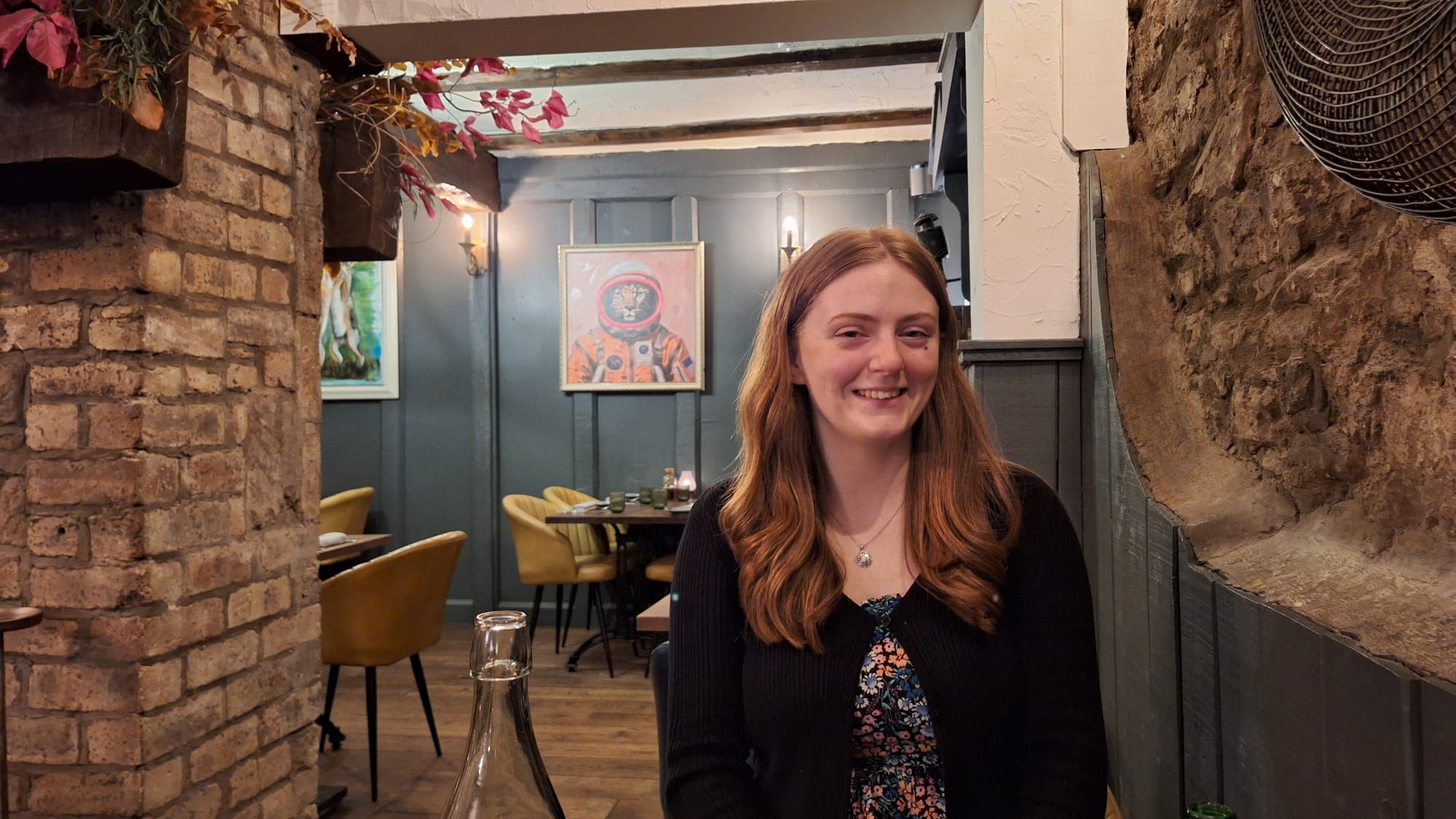 Beth smiles in the restaurant.