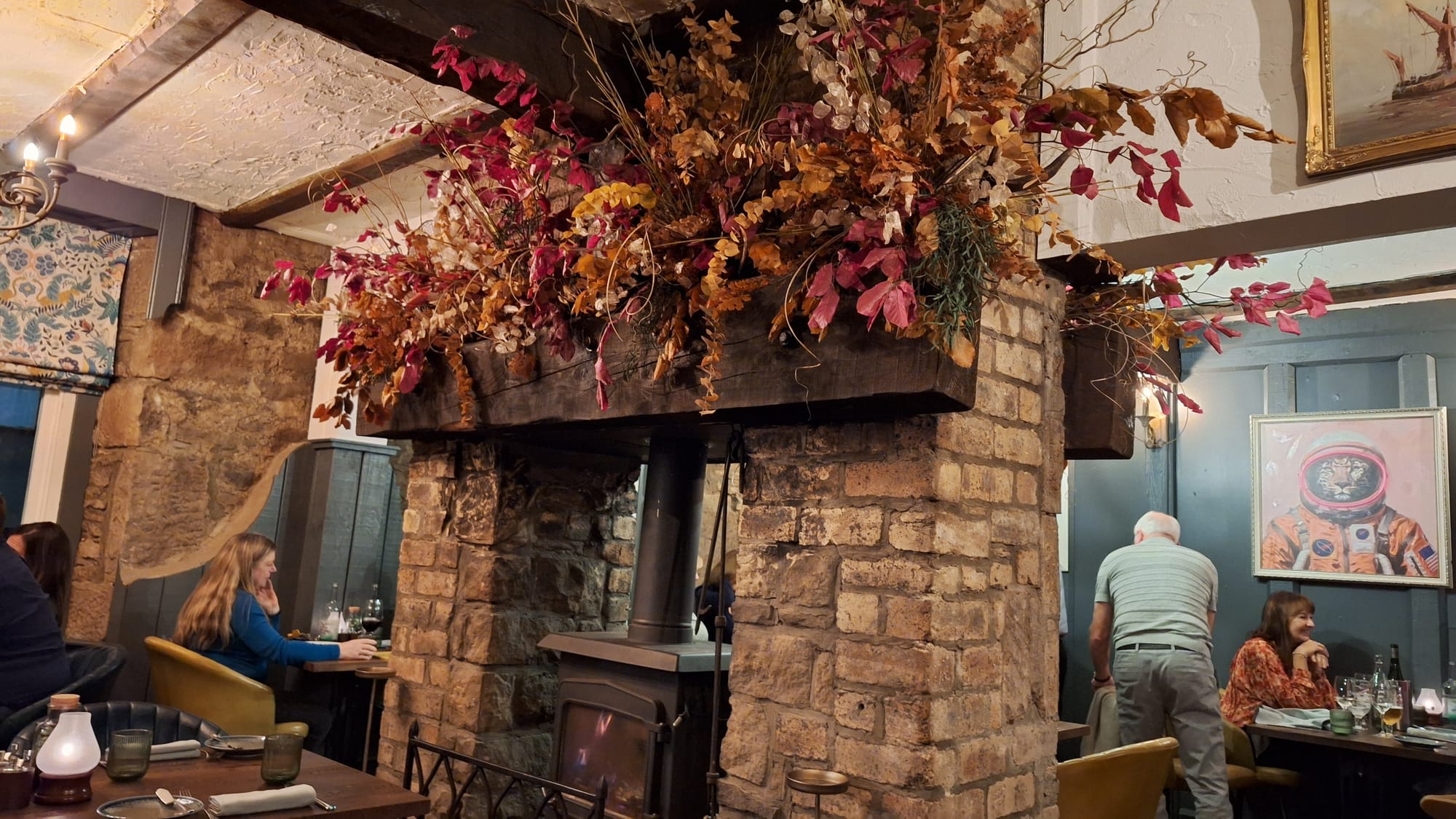 Red and orange flowers decorating a stone chimney breast.