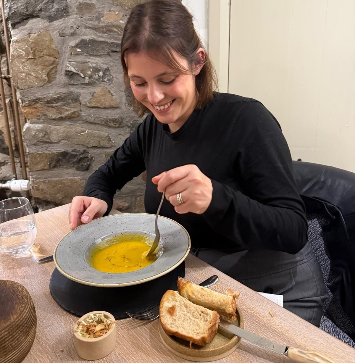 Daniella eating the third course of the tasting menu on the second night - a soup served with brioche