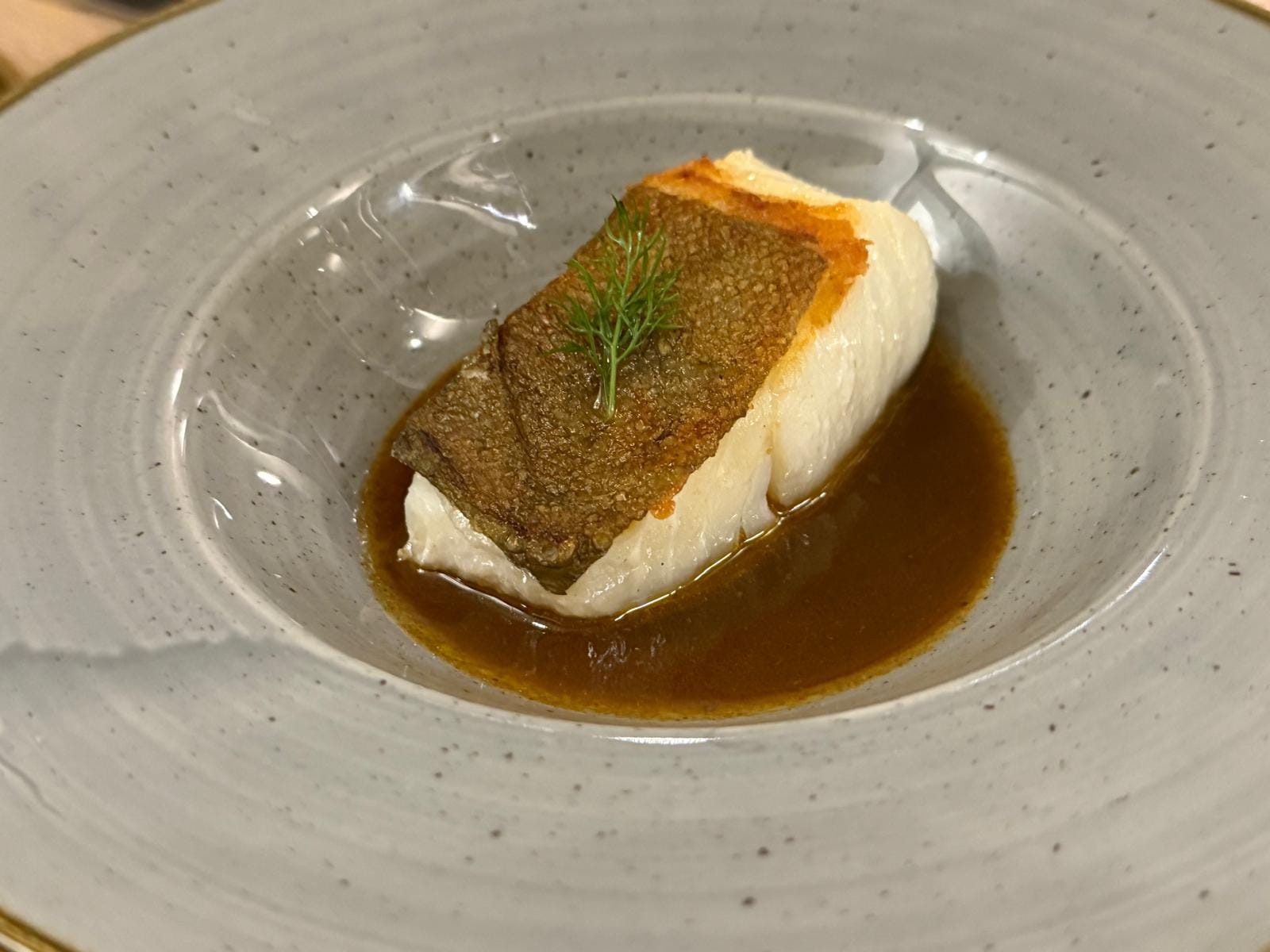 Close up of North Sea Cod, from Portree, and a sauce made from Langoustines from Loch Dunvegan