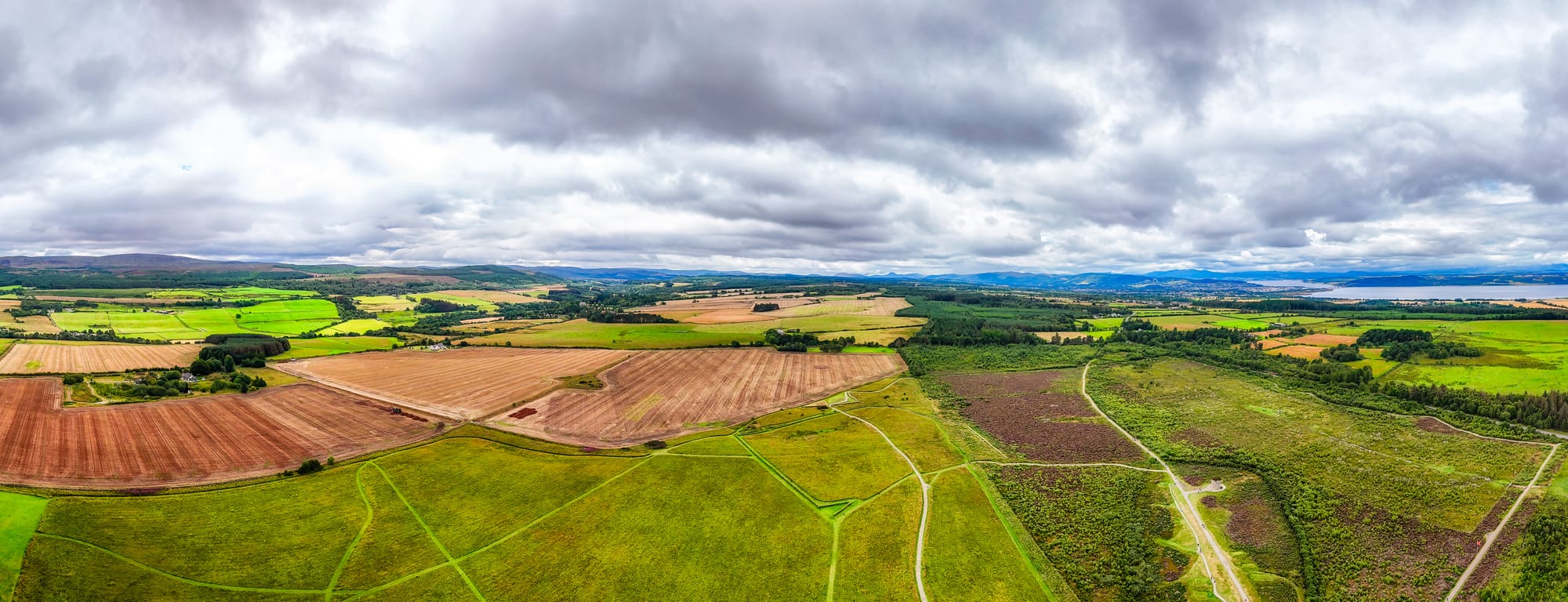 An aerial view of green and golden fields where the battle took place. 