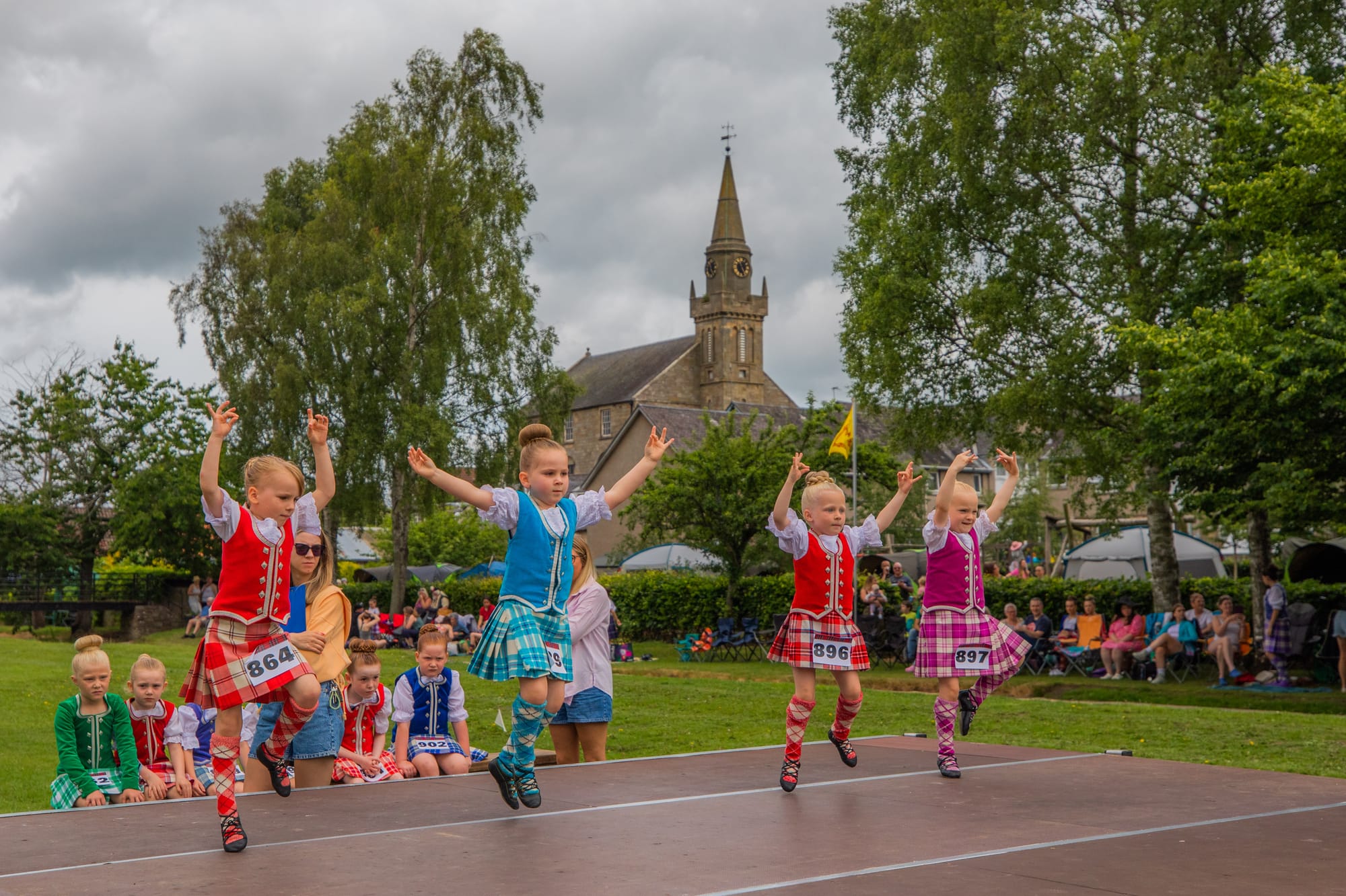 Four Highland dancers, all aged five, competing on stage the Ceres Highland Games in Fife.