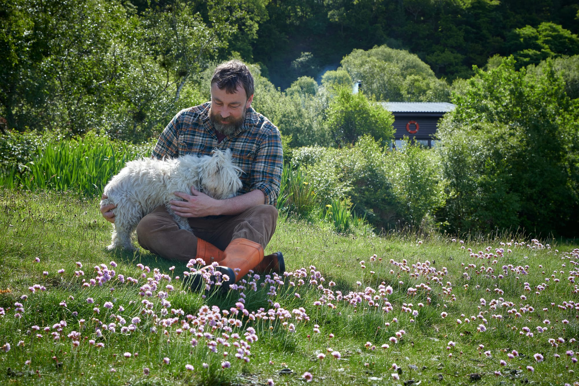 Peter cuddling with West Highland Terrier Seòras.