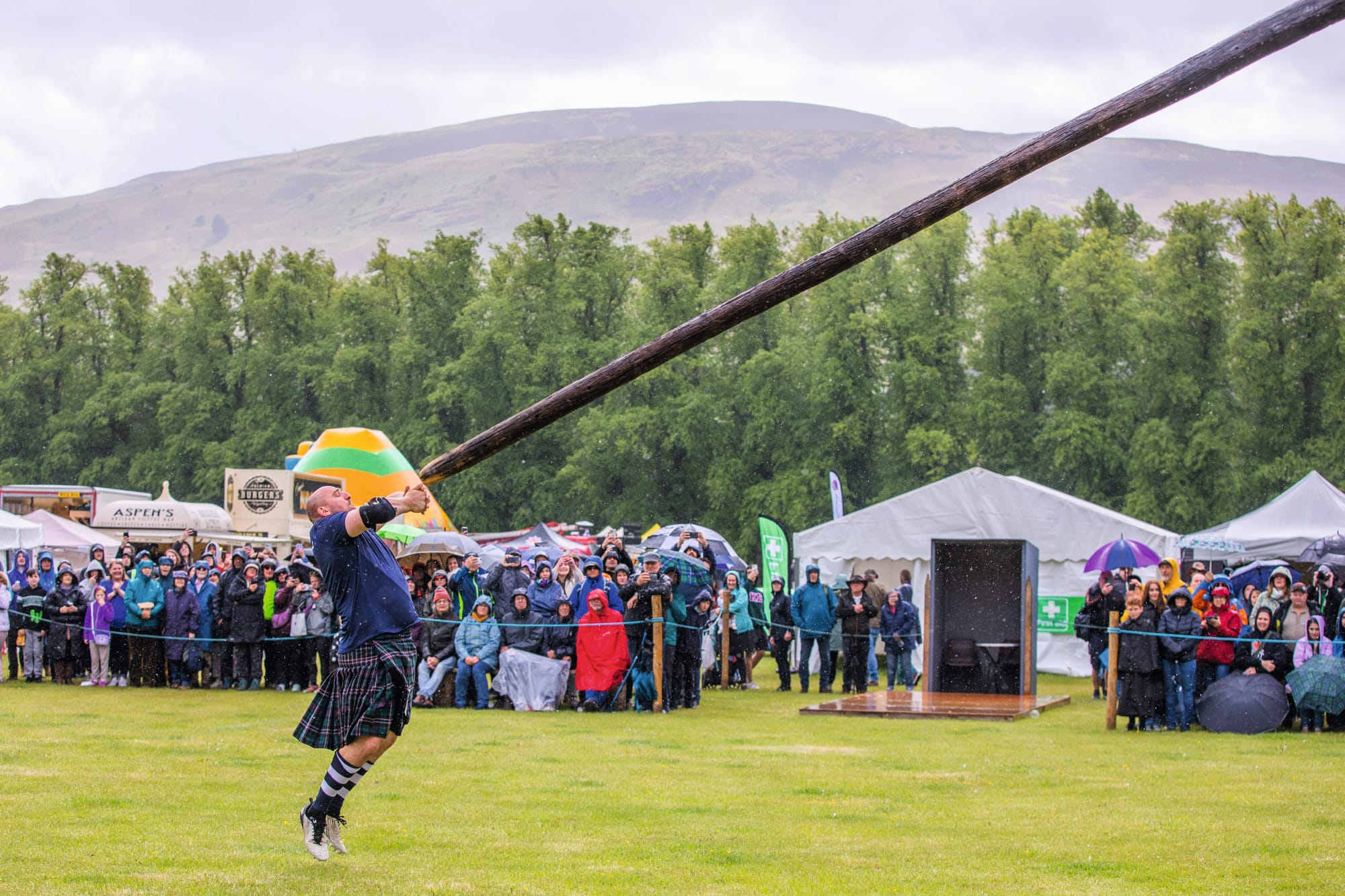 One contestant at The Atholl Gathering and Highland Games in a kilt is tossing the caber.