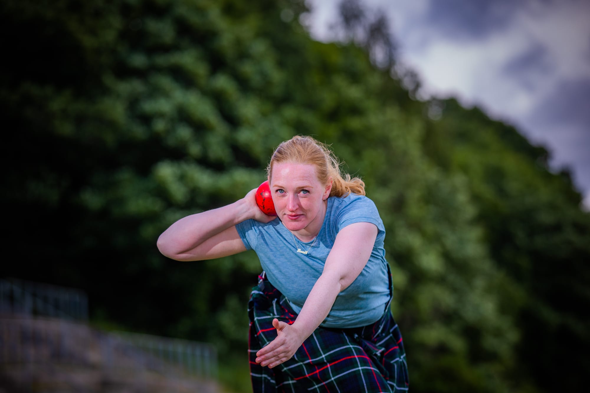 Ruadh McIntosh in a kilt holding a shot put.