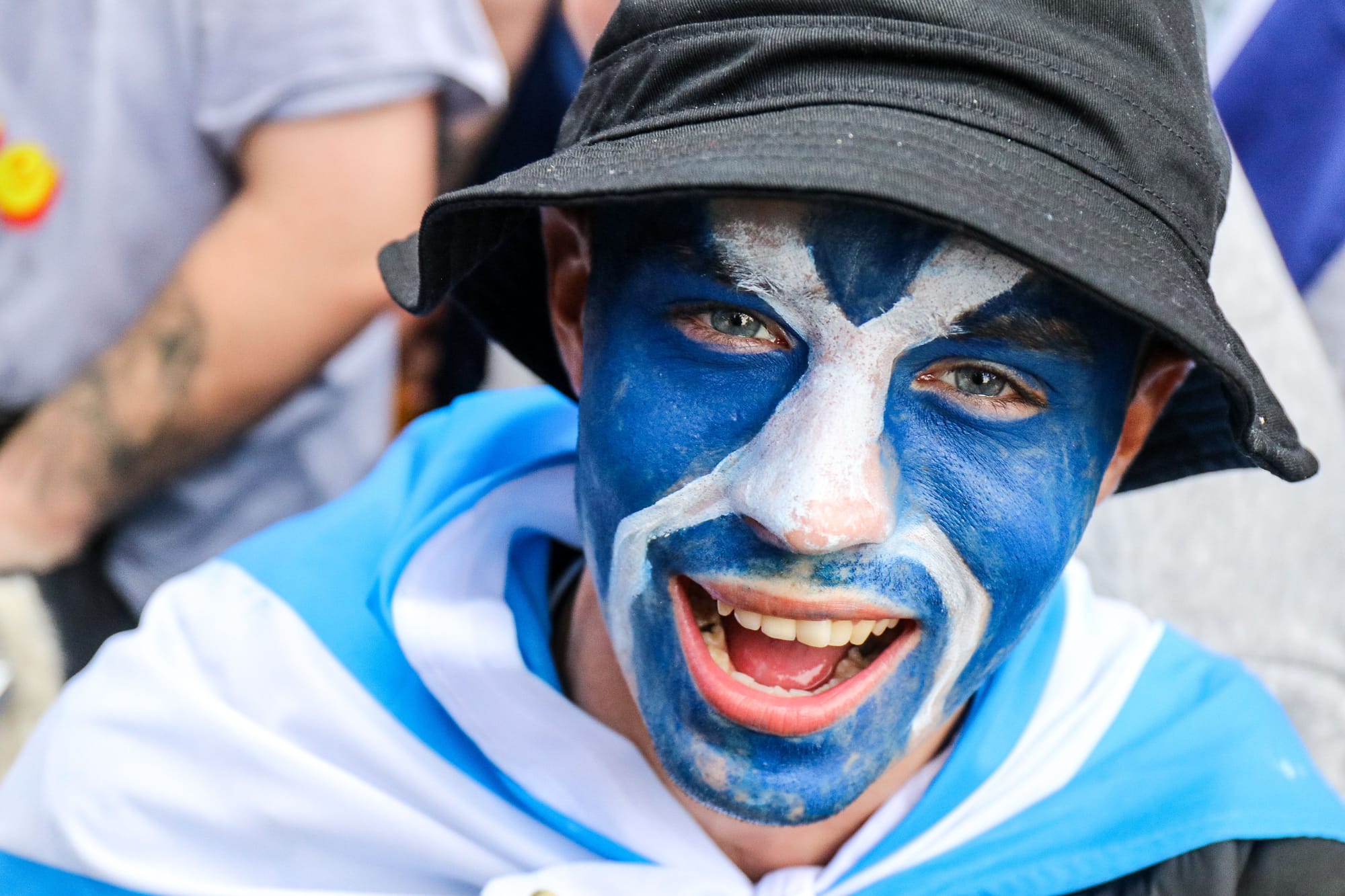 A Scotland fan with a Saltire painted across his face.