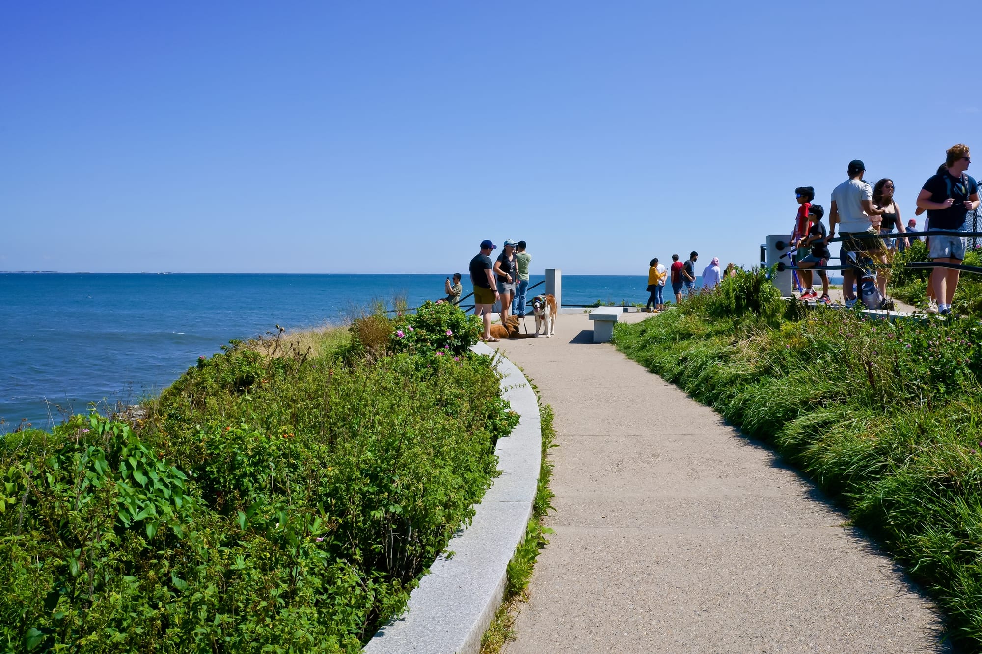 People on the Newport Cliff Walk which runs along the ocean.