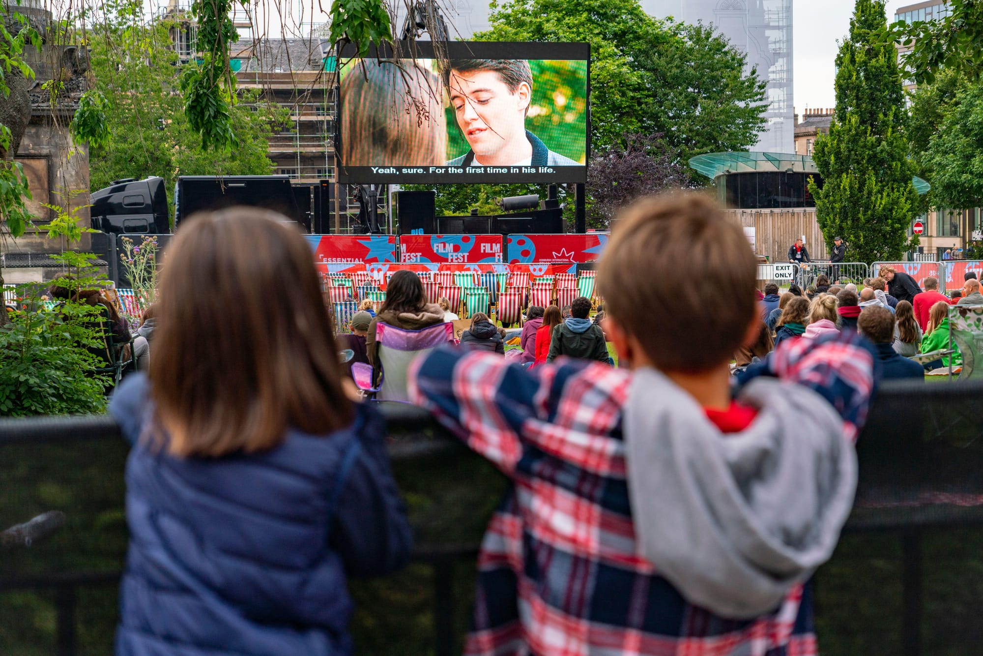 Two kids watch a screening at Edinburgh International Film Festival.