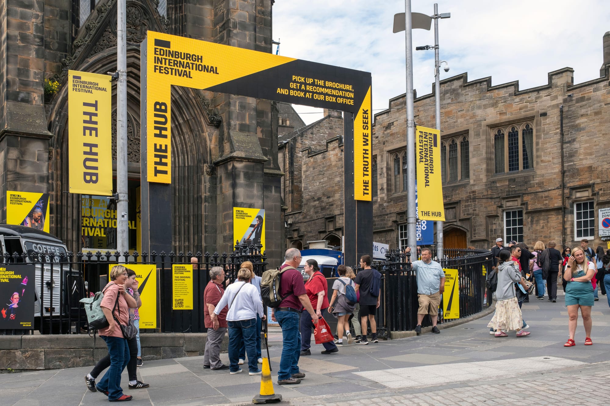 Yellow and black banners for Edinburgh International Festival at a previous year's festival hub.