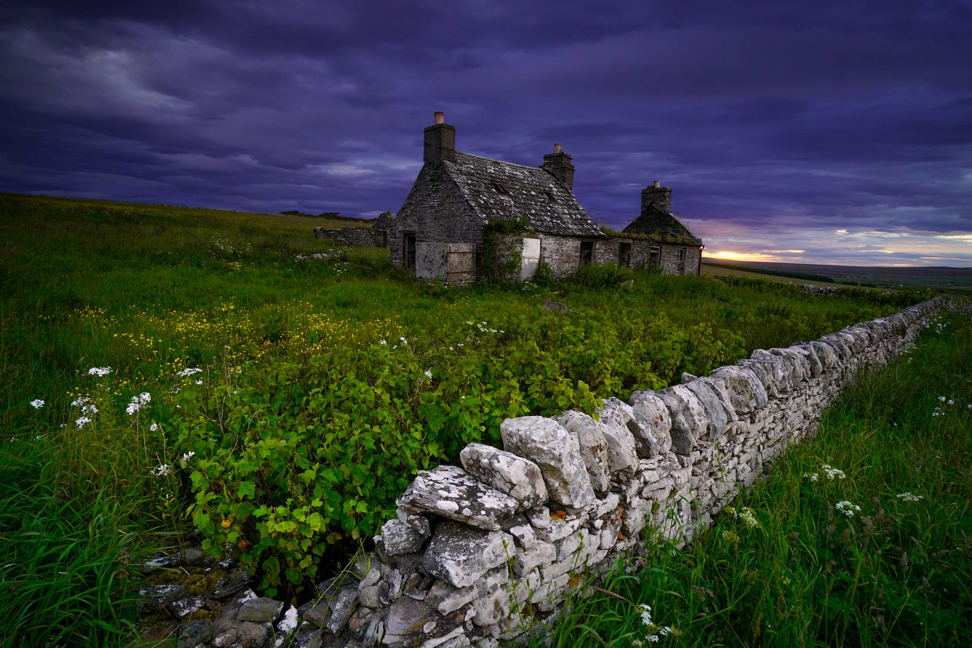 A cottage with a purple sky behind.