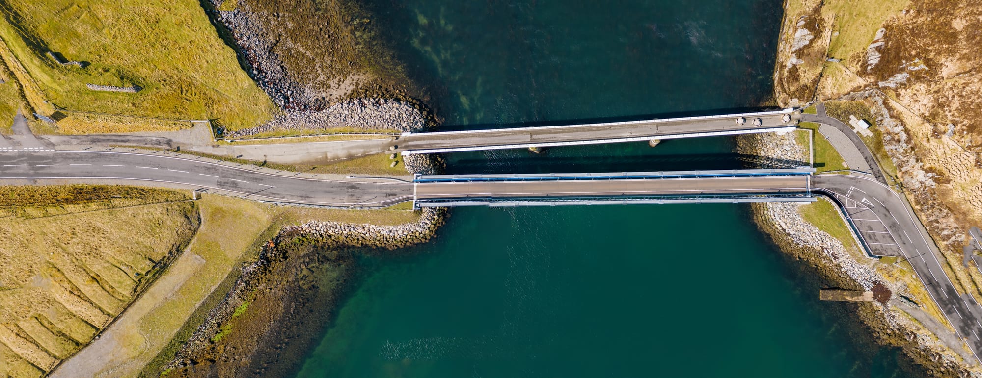 The bridge from the Isle of Lewis to Great Bernera - the bridge stretches across the water with two roads, separated in the middle.