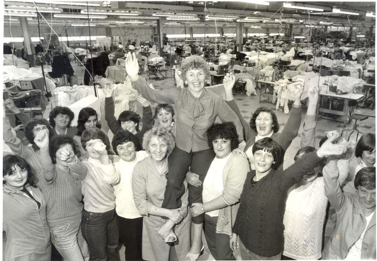A group of 17 women celebrate the success of the sit in, with Helen being carried aloft her colleagues' shoulders. 