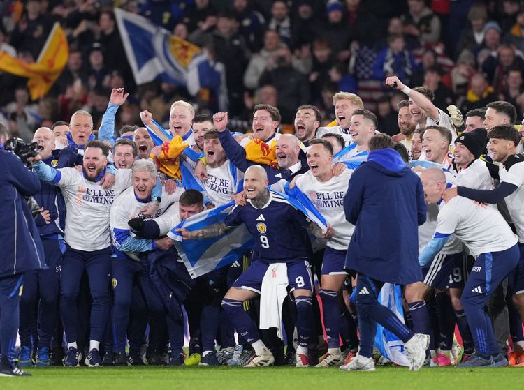 The Scottish men's national team celebrate on the pitch after beating Denmark 4-2 to qualify for the FIFA World Cup 2026 on November 18, 2025.