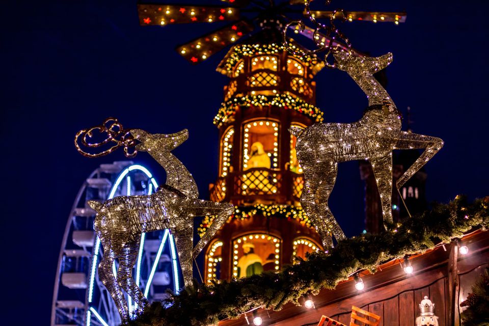 Christmas decorations at a market lighting up the night sky.