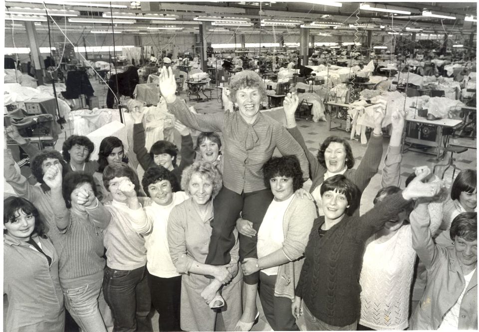 A group of 17 women celebrate the success of the sit in, with Helen being carried aloft her colleagues' shoulders. 