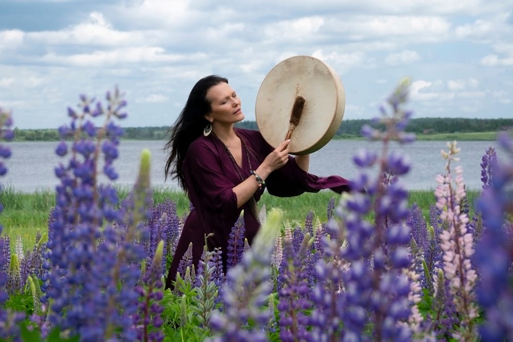 person playing drum among flowers