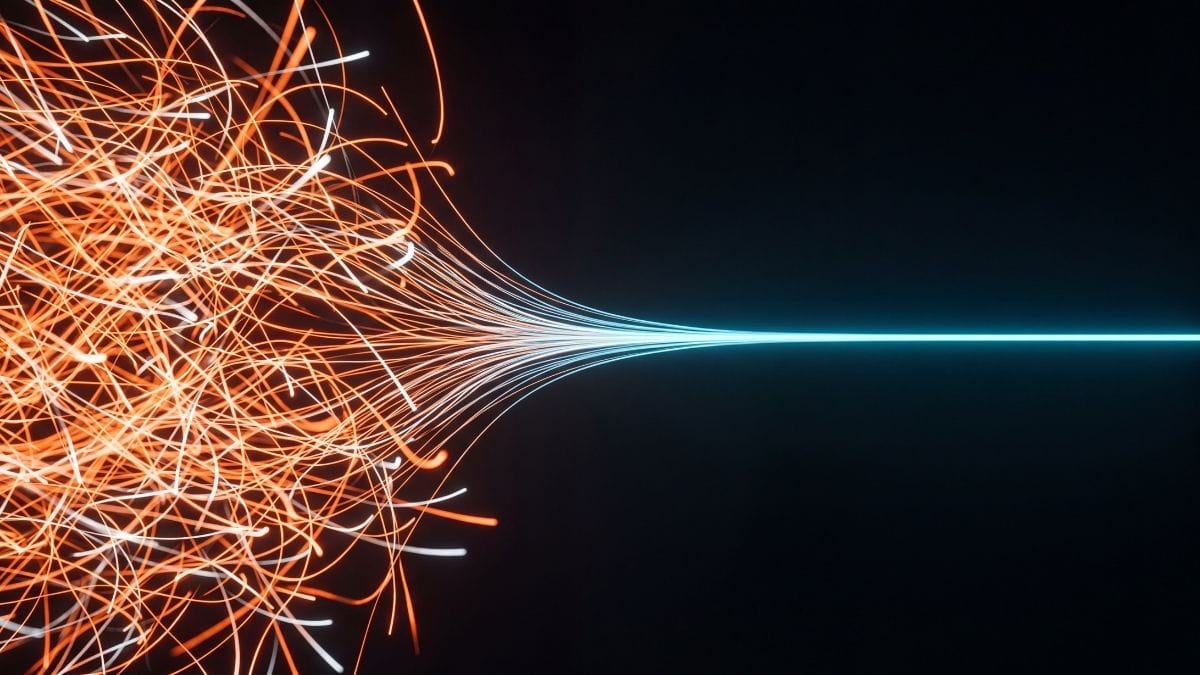 Abstract representation of chaotic light trails transforming into a single calm line, illustrating nervous system regulation.