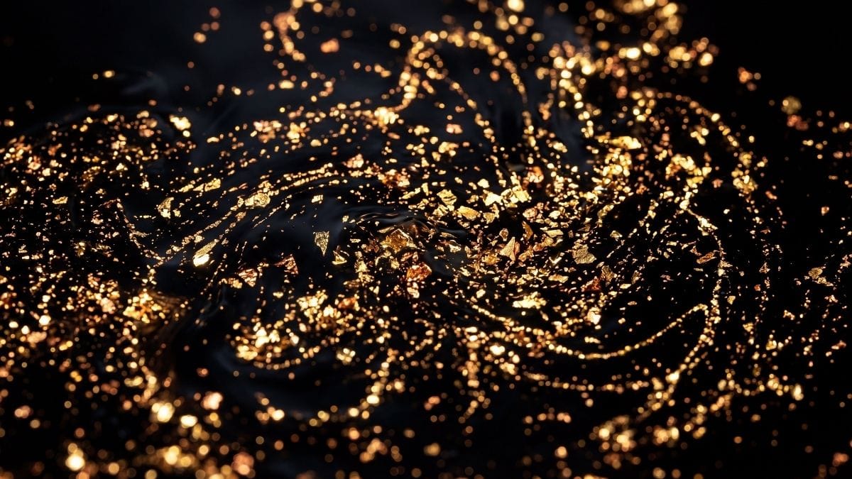 Abstract gold and copper particles swirling in dark fluid, representing an unsettled nervous system.