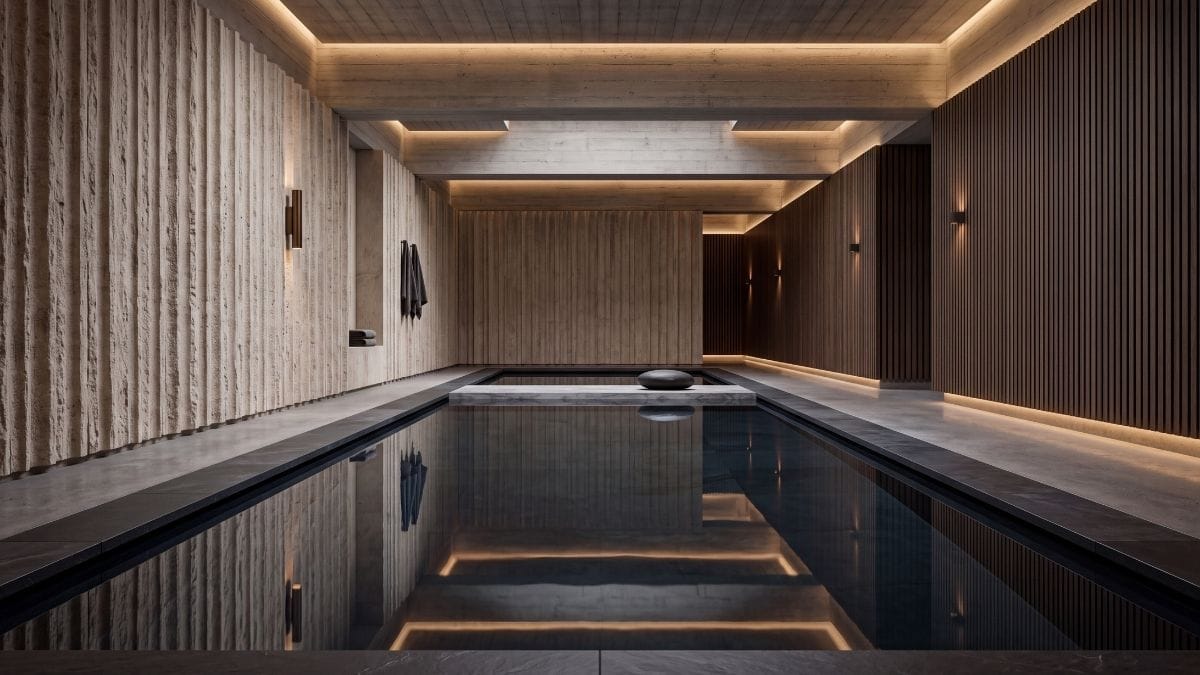 Still slate reflecting pool in a minimalist luxury spa pavilion with fluted limestone walls.