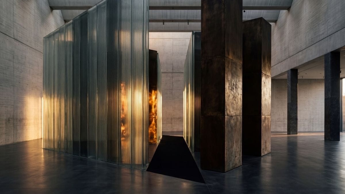Monolithic fluted glass screens separated by shadow, representing synthetic clarity and communication gaps.