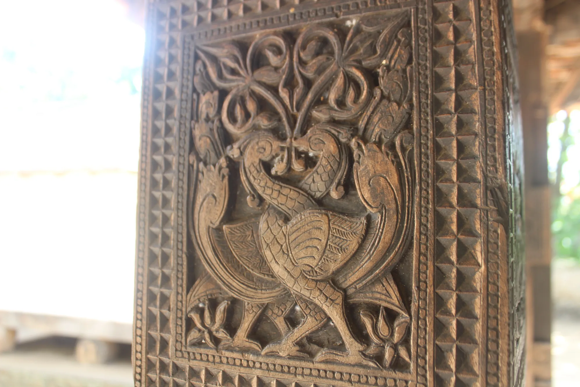 Wooden carving of two peacocks at Embekka Devalaya, Sri Lanka