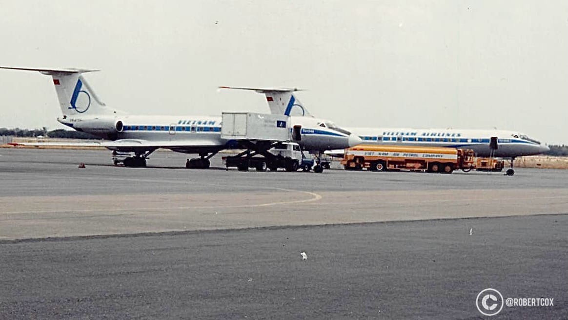 This image shows Two Vietnam Airlines planes — Tupolev Tu-134s, Soviet-designed twin-engine jet airliners commonly used by Vietnam Airlines in the 1990s —on the tarmac at Tan Son Nhat International Airport in Ho Chi Minh City, Vietnam on April 30 1995. One of them was my plane.
