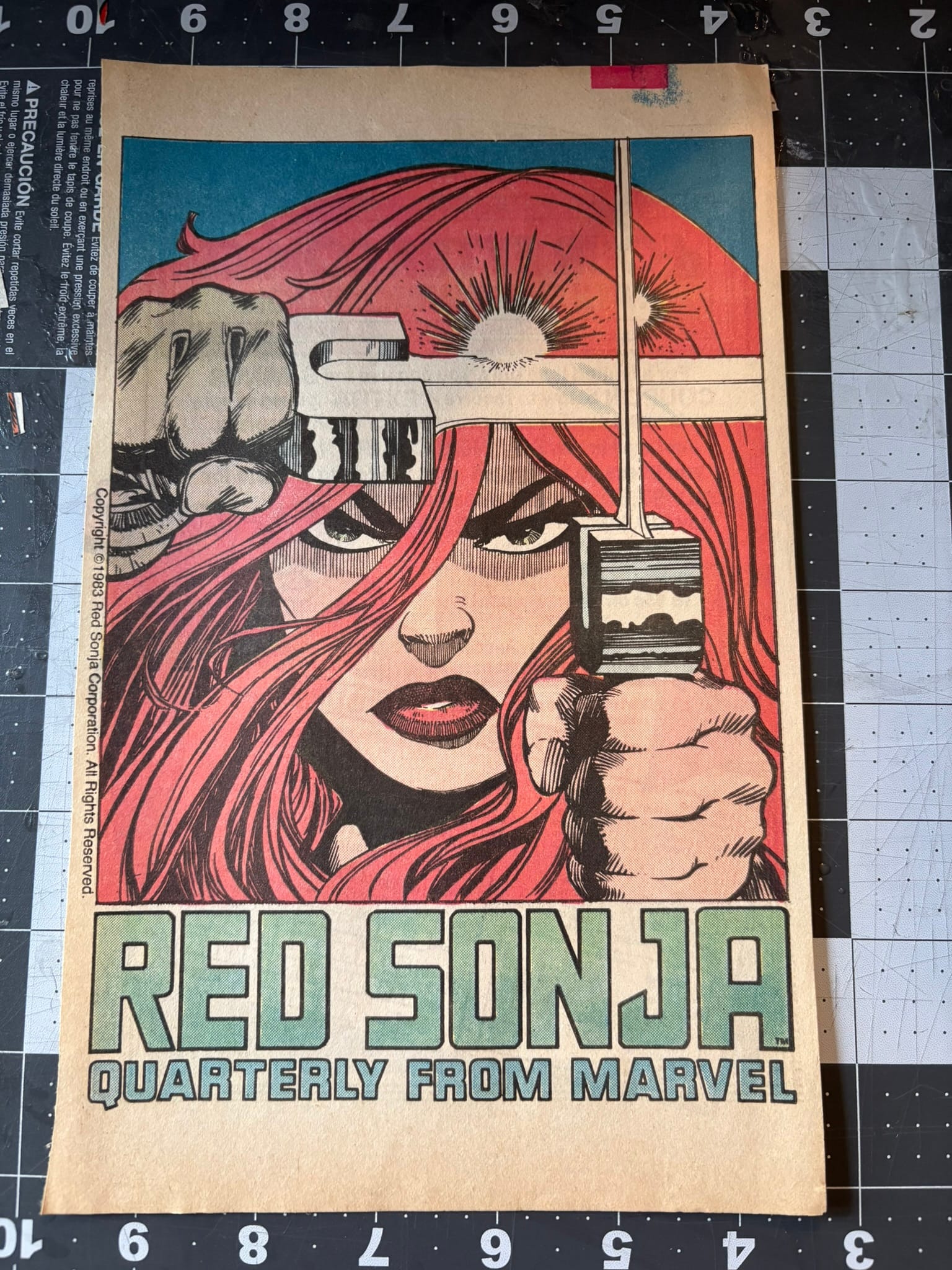 advertisement for the Red Sonja Marvel comic, featuring a close-up image of Red Sonja holding two swords in a fighting stance.
