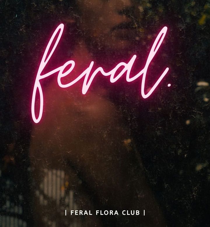 Bright pink text reads FERAL, designed to look like an illuminated neon sign, illuminates a dark botanical background with obscured person looking over their shoulder "Feral Flora Club"