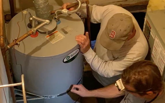 Old gas water heater being replaced by HPWH