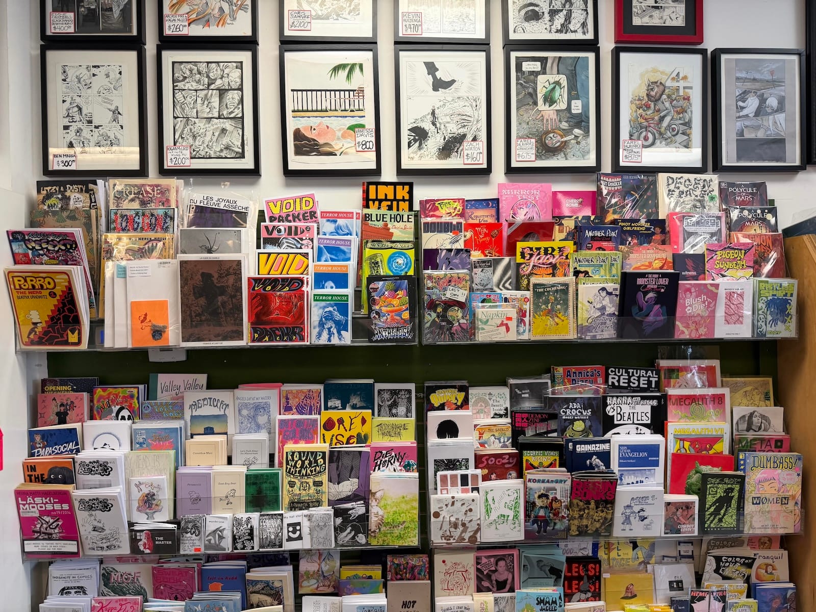 A periodicals rack that is stocked with indie comic zines from local creators.