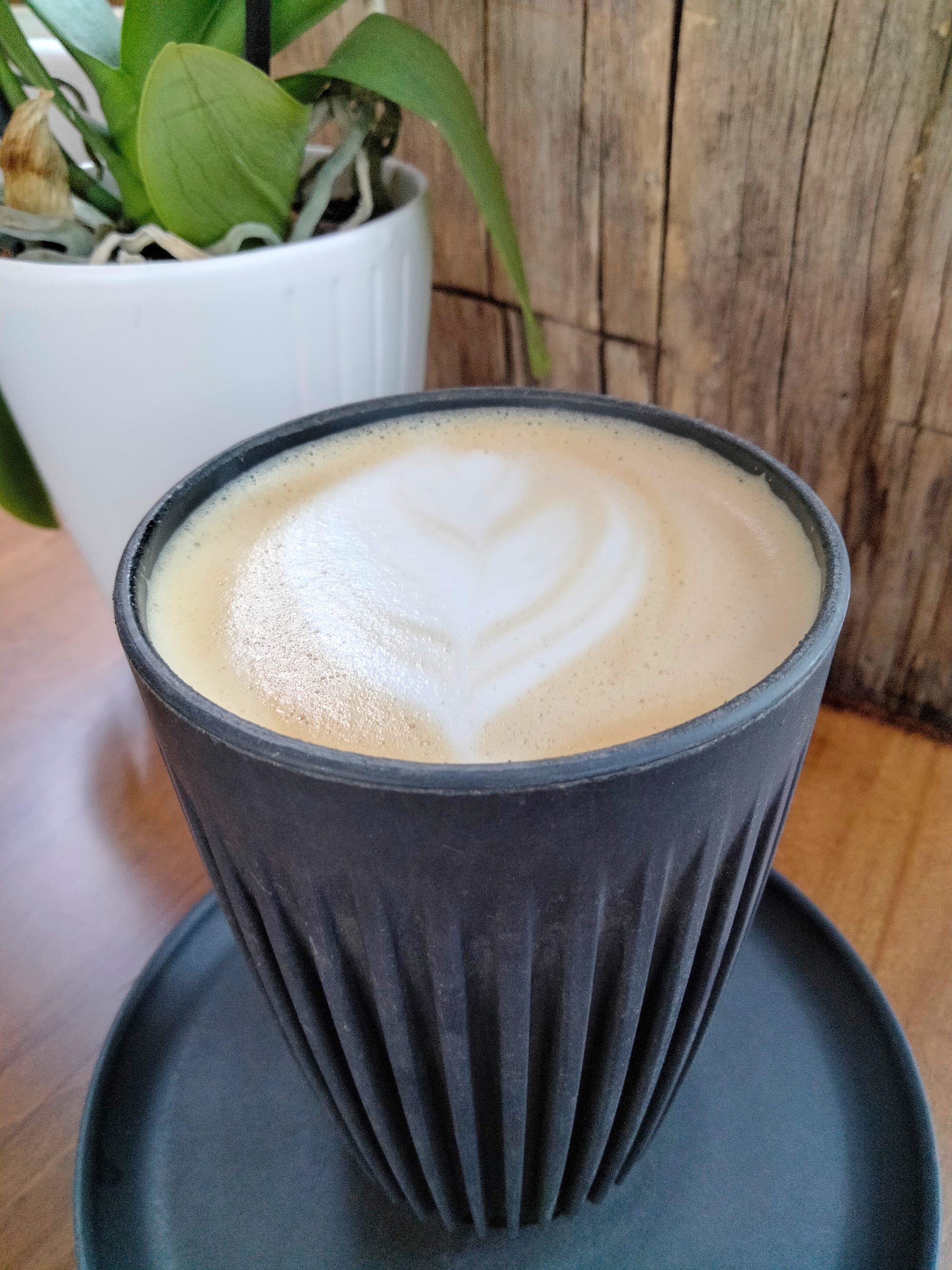 The Craftsman at Heritage Coffee with a flower design on top