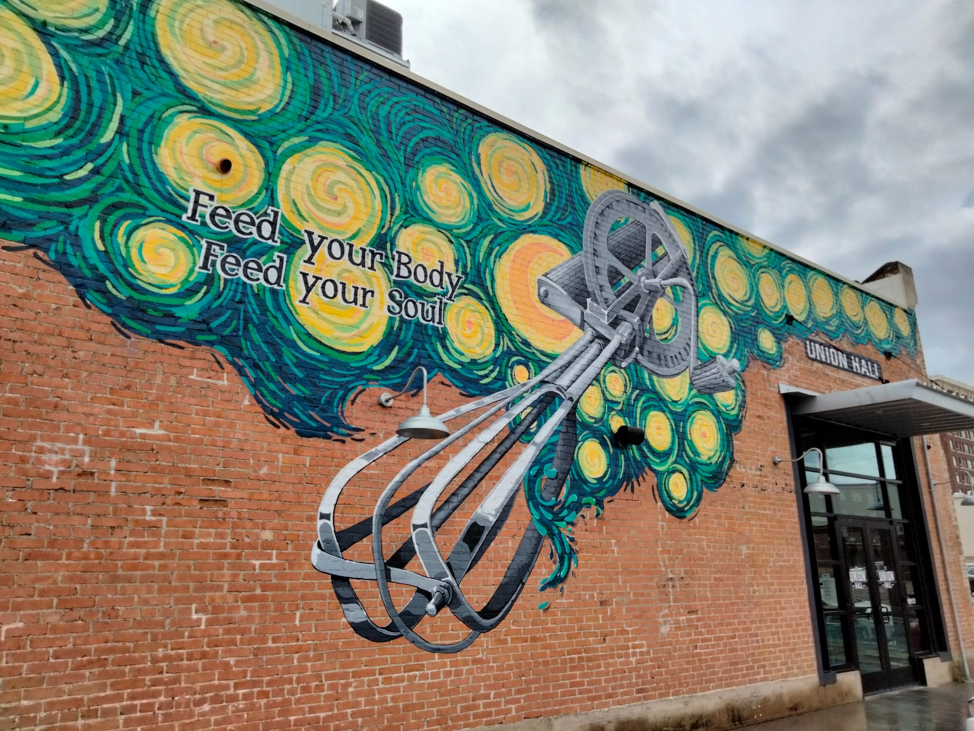 A wall mural with Waco street art on the side entrance to Union Hall, a local eatery in downtown, Waco, TX