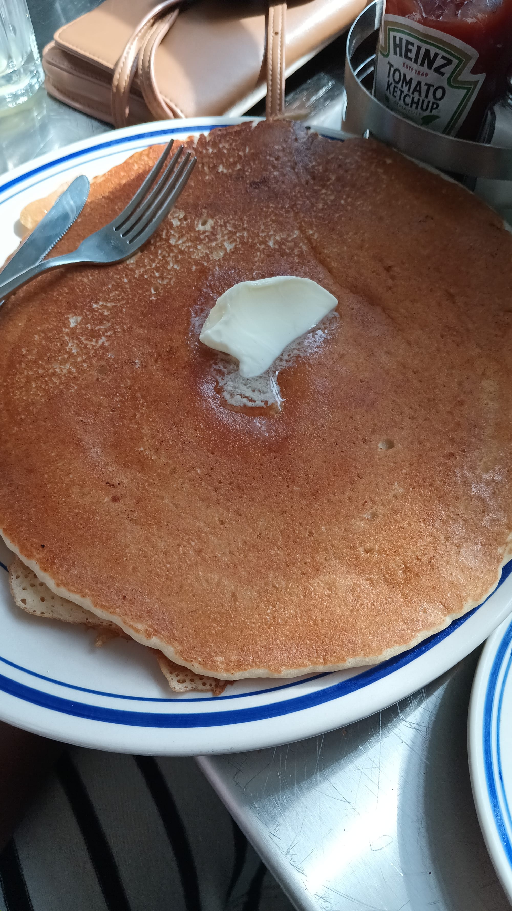 Massive pancakes taking up the whole plate at Beau's Tiny Diner, San Antonio, TX