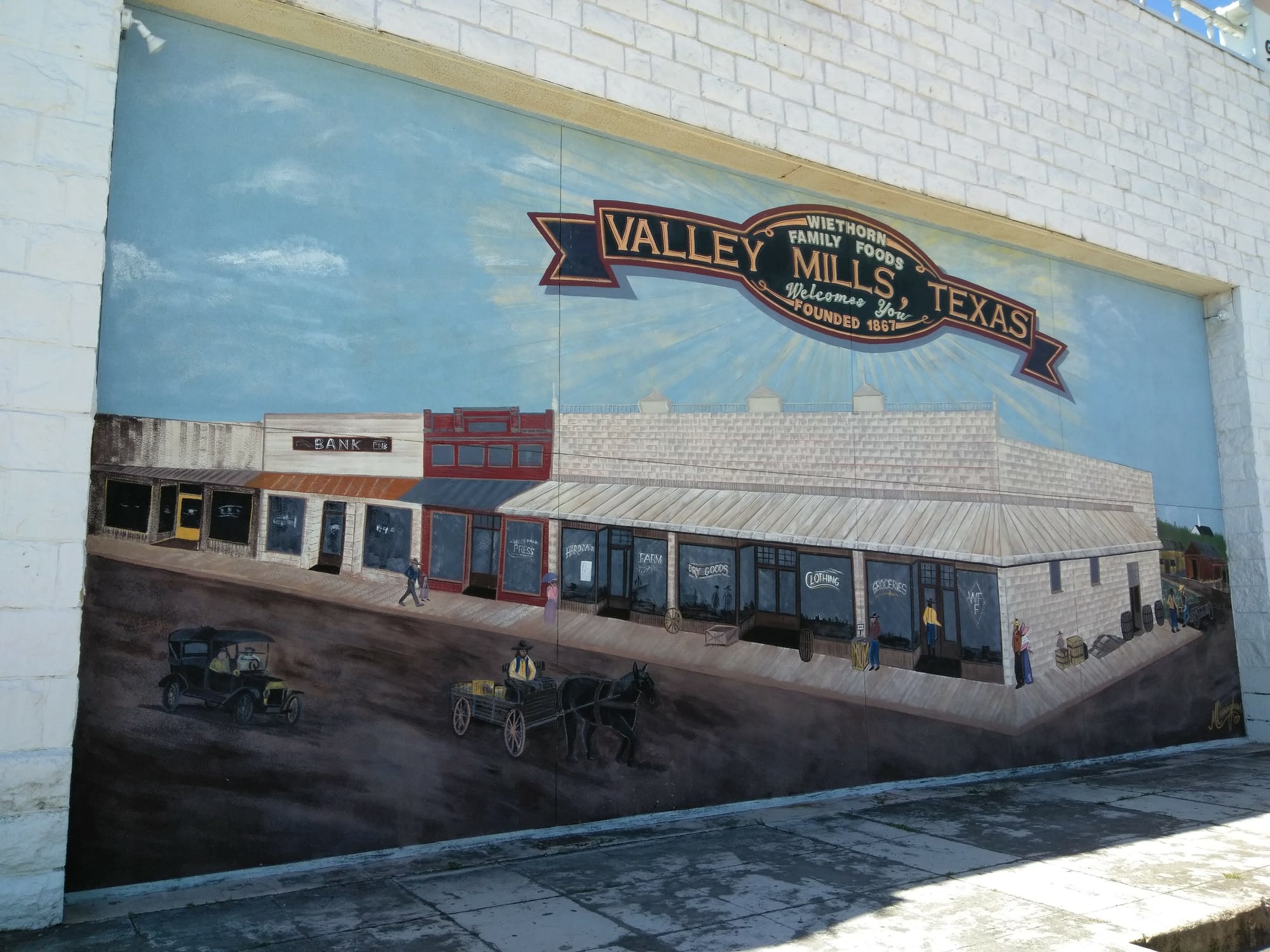 A wall mural depicting life in Valley Mills, TX from the old western days