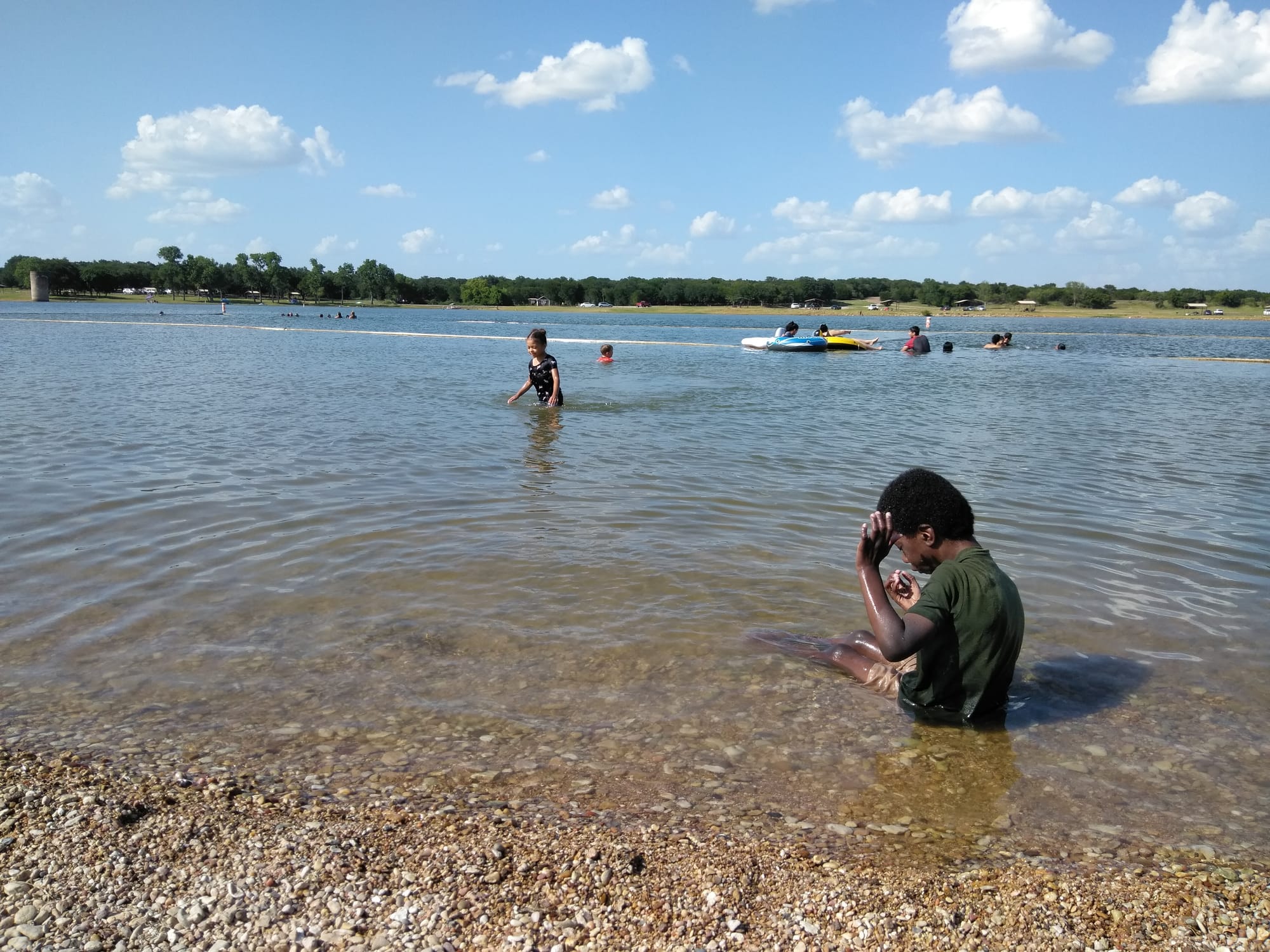 People swimming in Lofers Bend Park at Lake Whitney