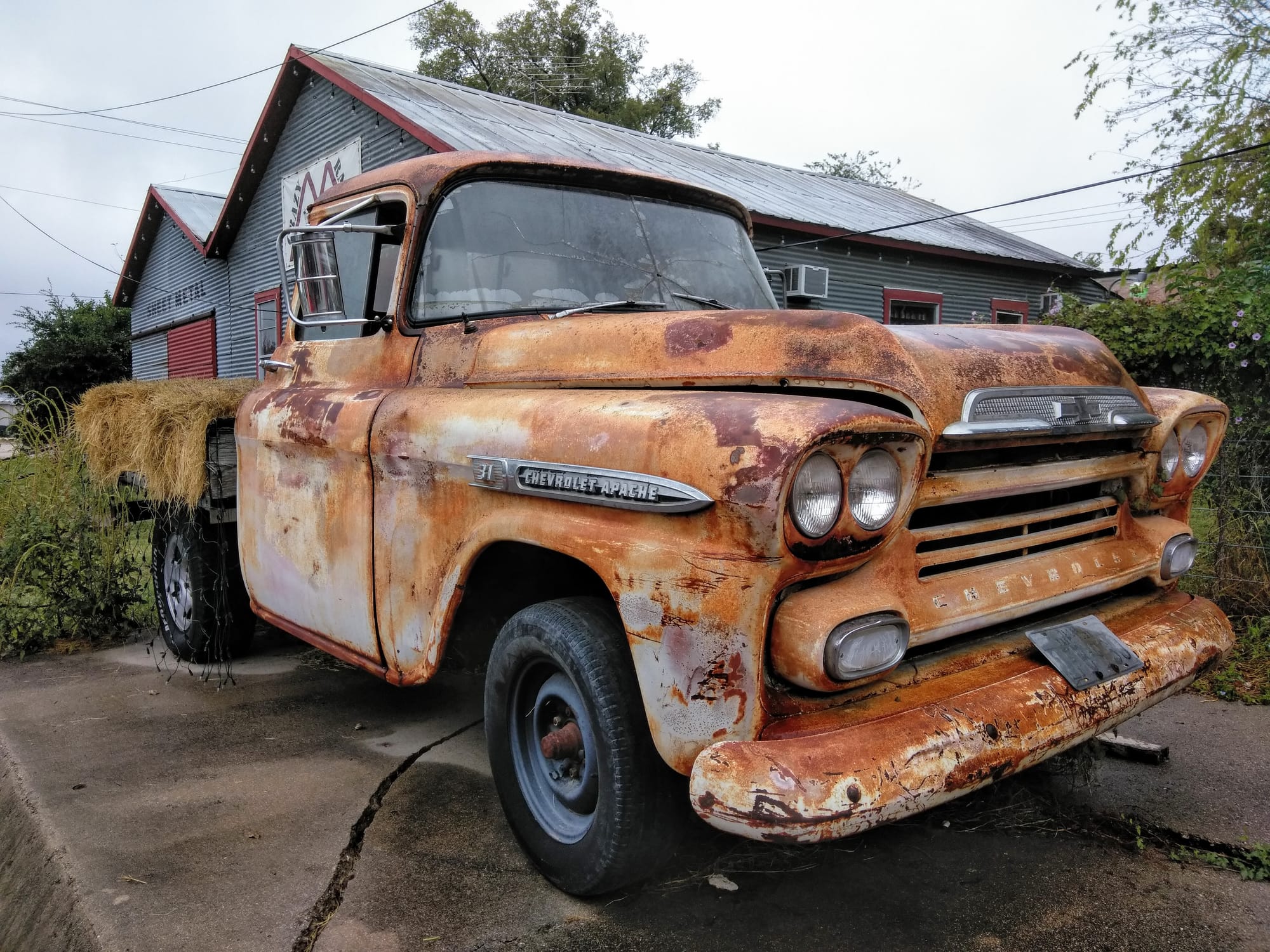 An old, rusted Chevrolet Apache truck in Clifton, TX on display
