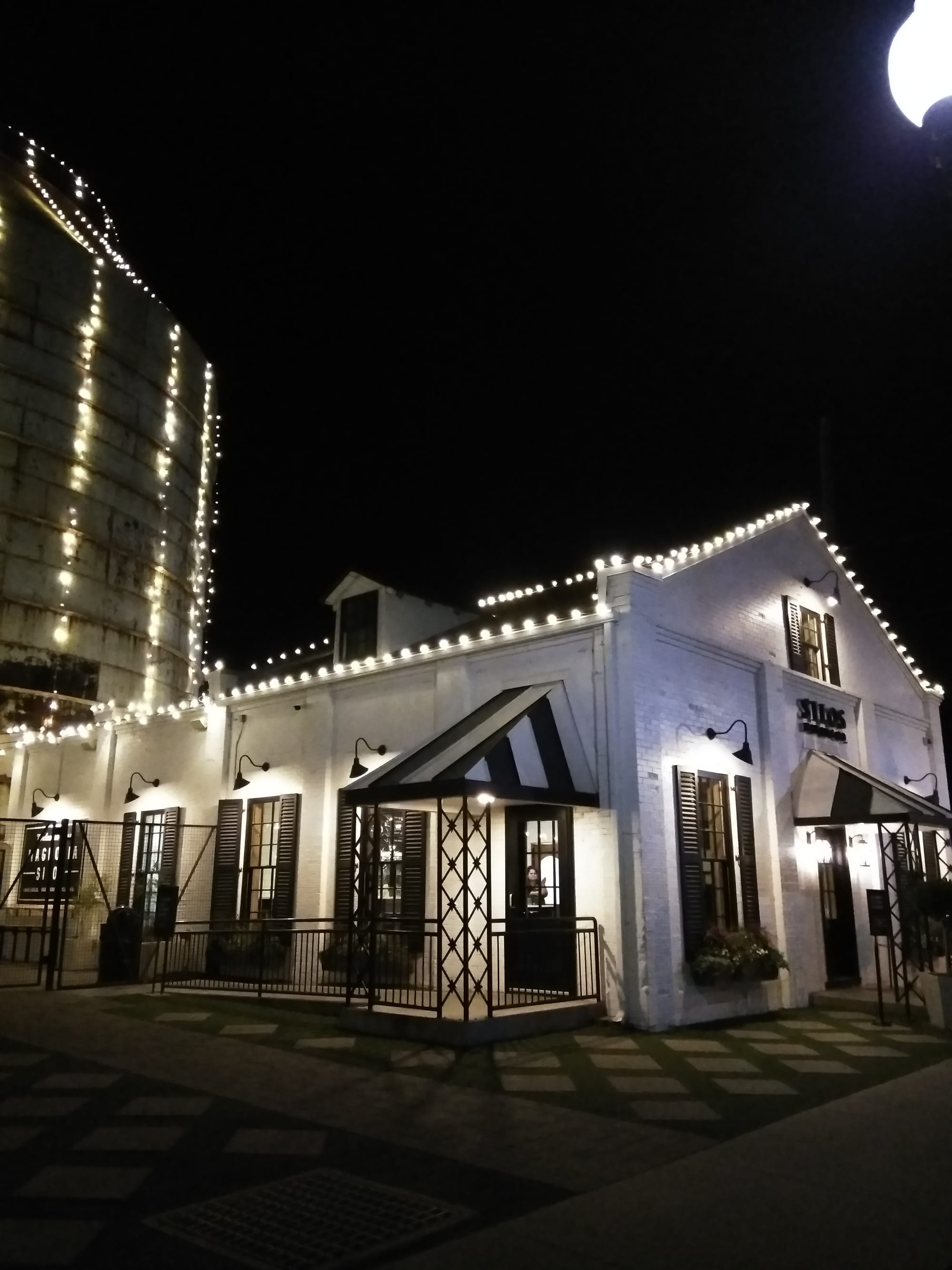 Magnolia Bakery lit up at night, one of the best dessert places in Waco, TX