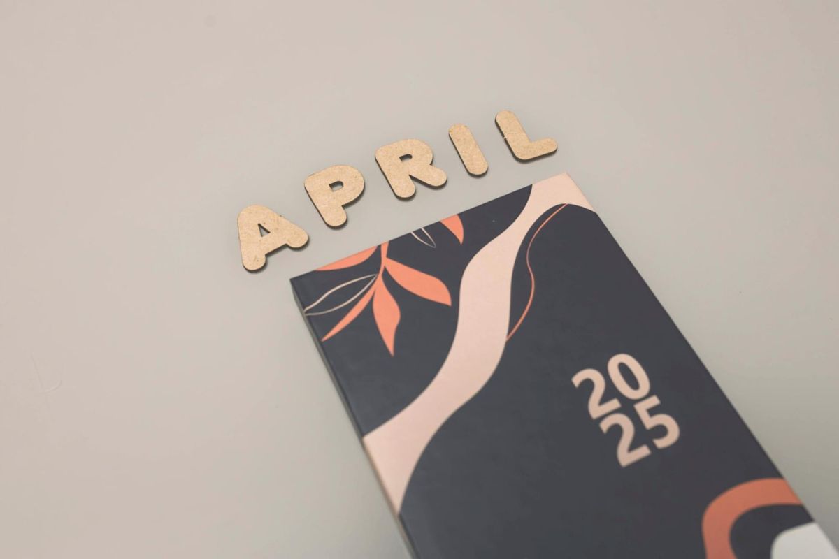 2025 calendar and April lettering styled in a neutral flat lay, perfect for blog posts about best books of the year or spring reading favorites.
