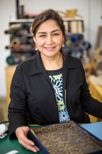 Photo of Tieton resident Maria Solorio, who runs the bindery at Paper Hammer studio, by Arturo Solorio
