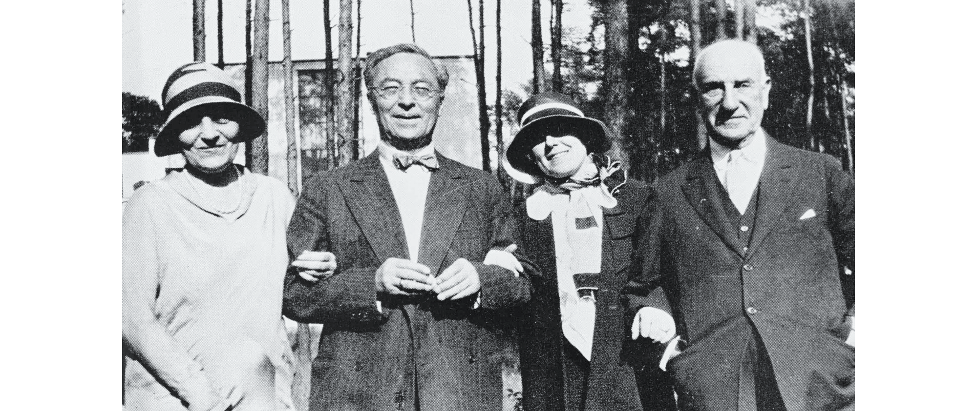 Photo of 4 adults linking arms